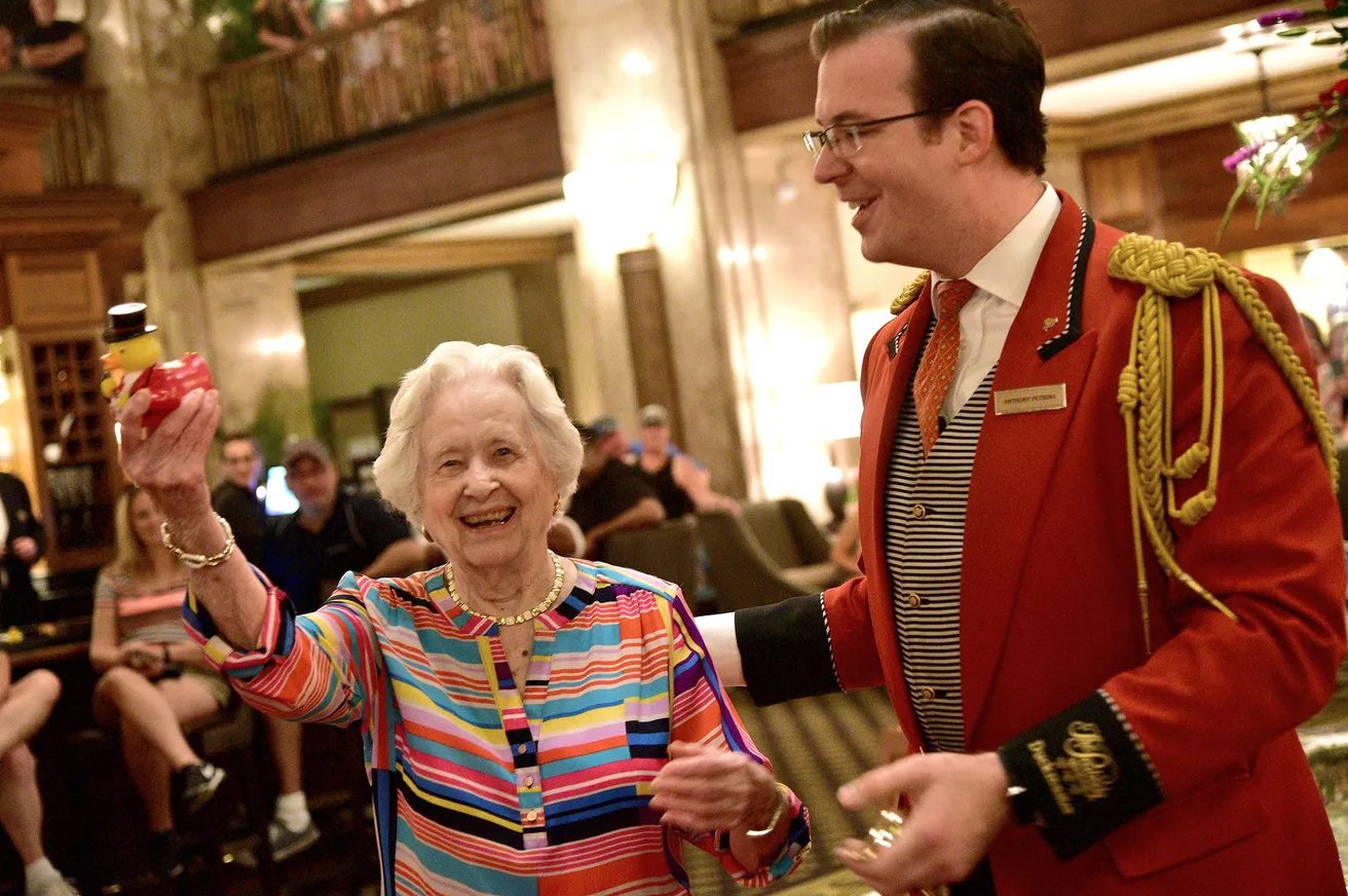 Auntie Opal laughing with the Peabody Duckmaster on her 100th birthday