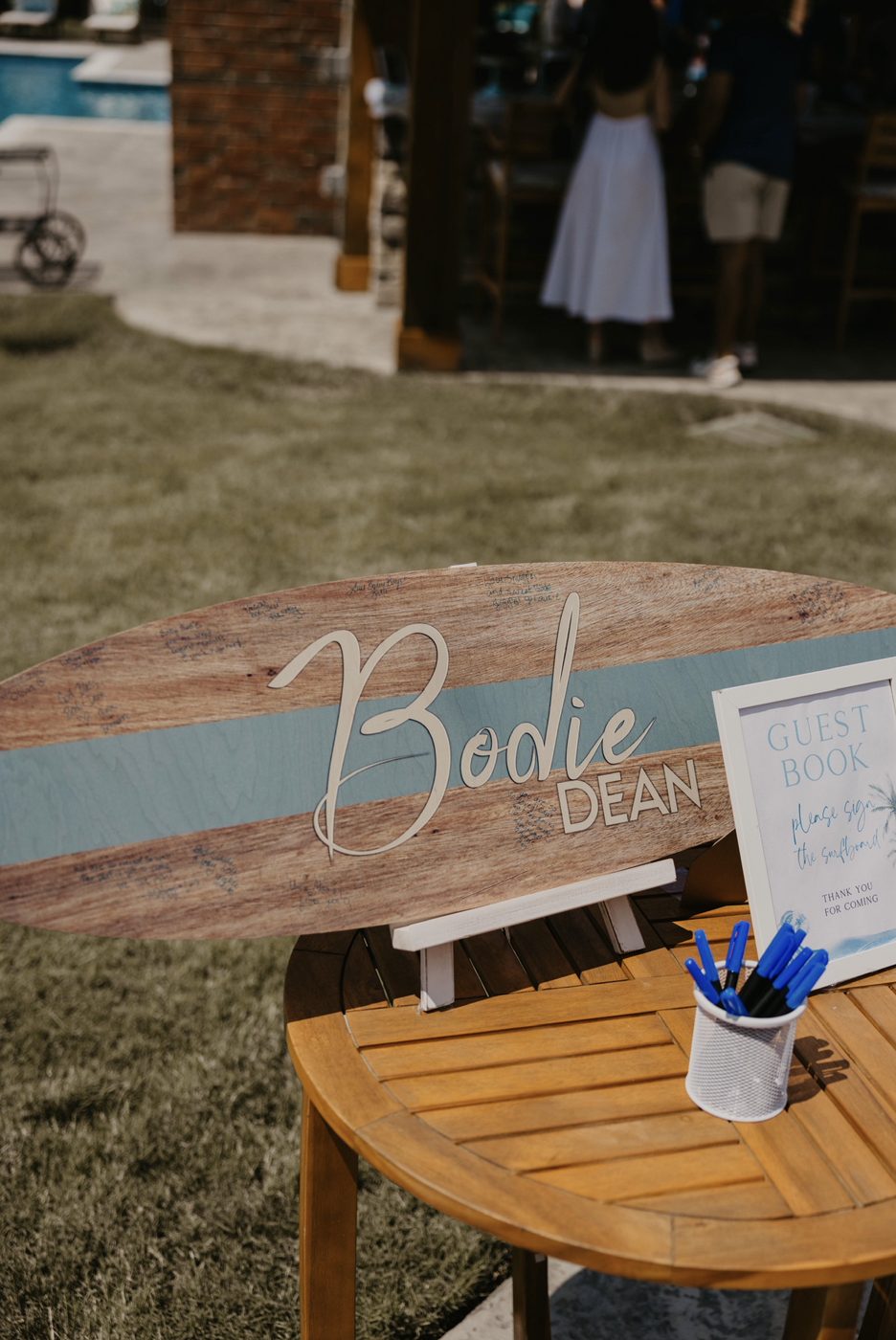 A wooden surfboard guestbook signed by guests
