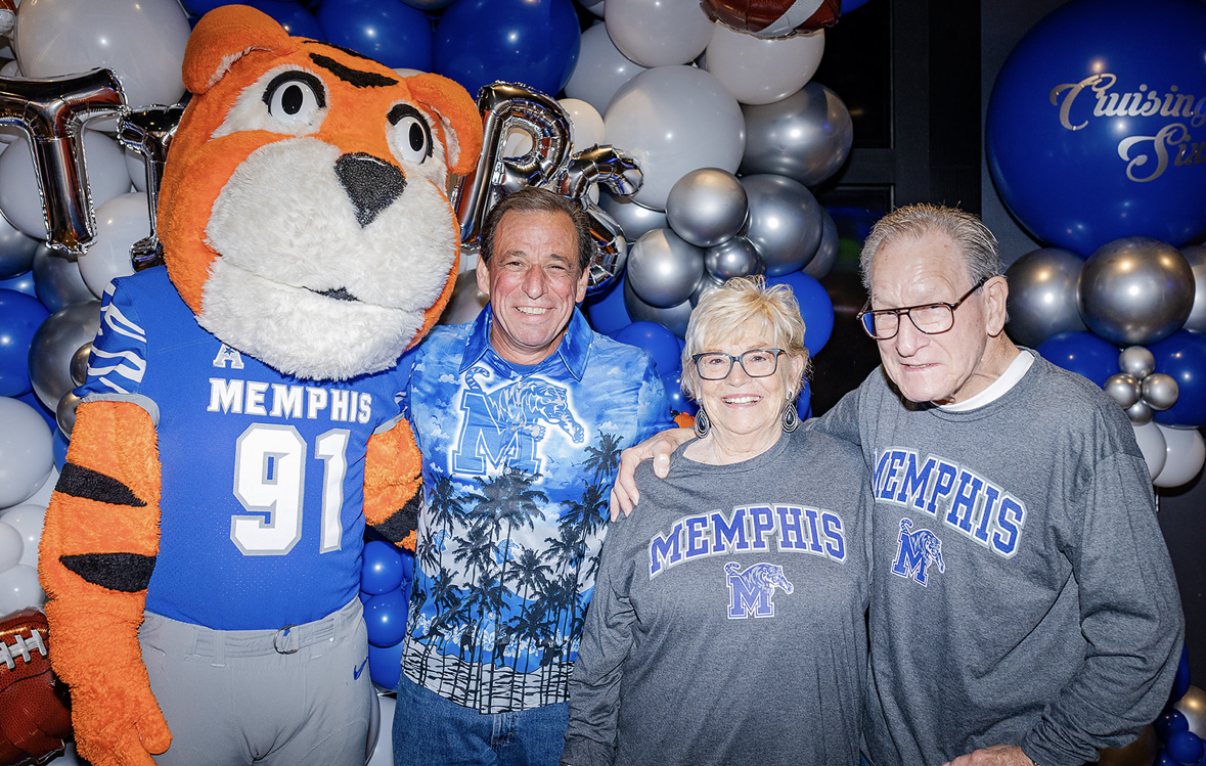 TOM the Memphis Tigers mascot with the guest of honor and family in Tigers gear